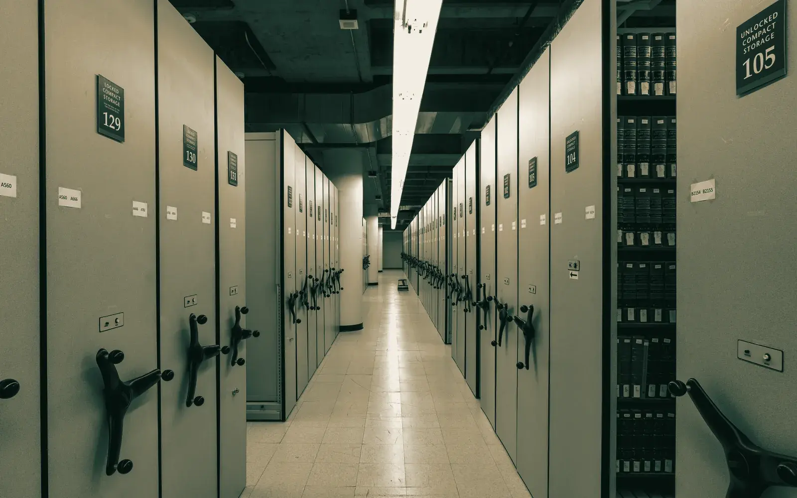 A closed-stack archive aisle, file cabinets on both sides.
