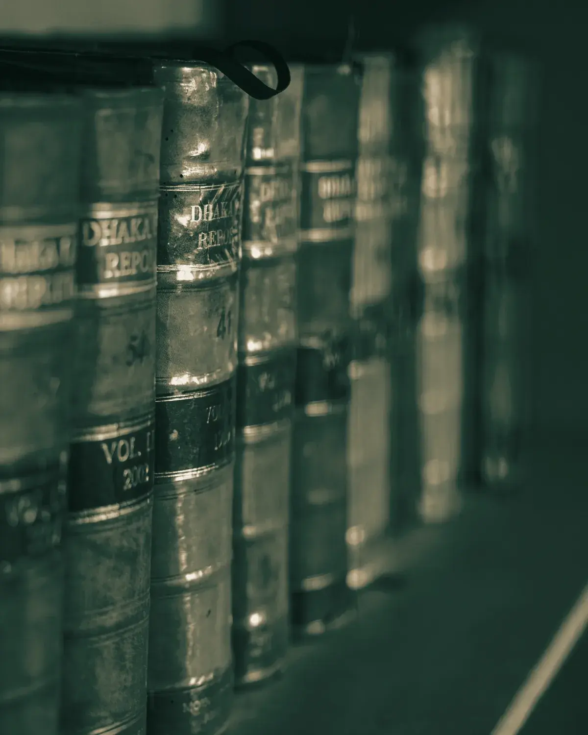 A shelf of bound case reports, spines in shallow focus.
