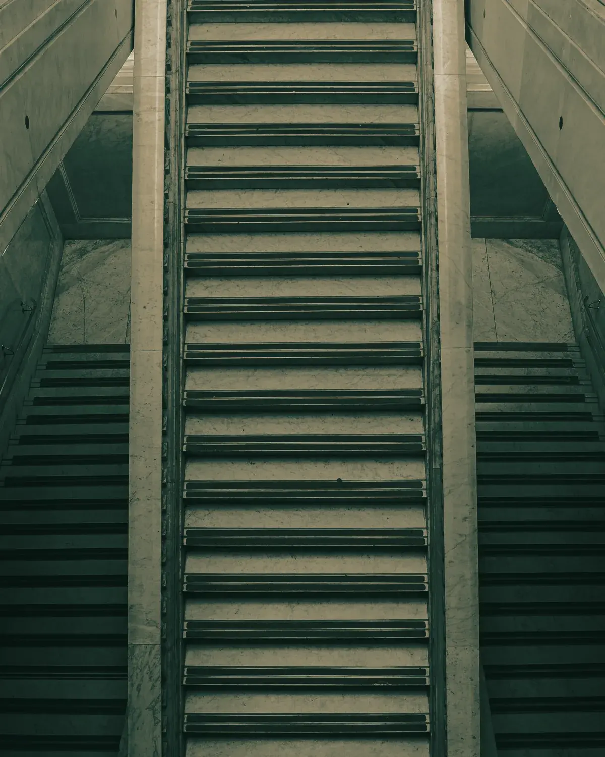 The stone stair at a courthouse west entrance, seen from below.