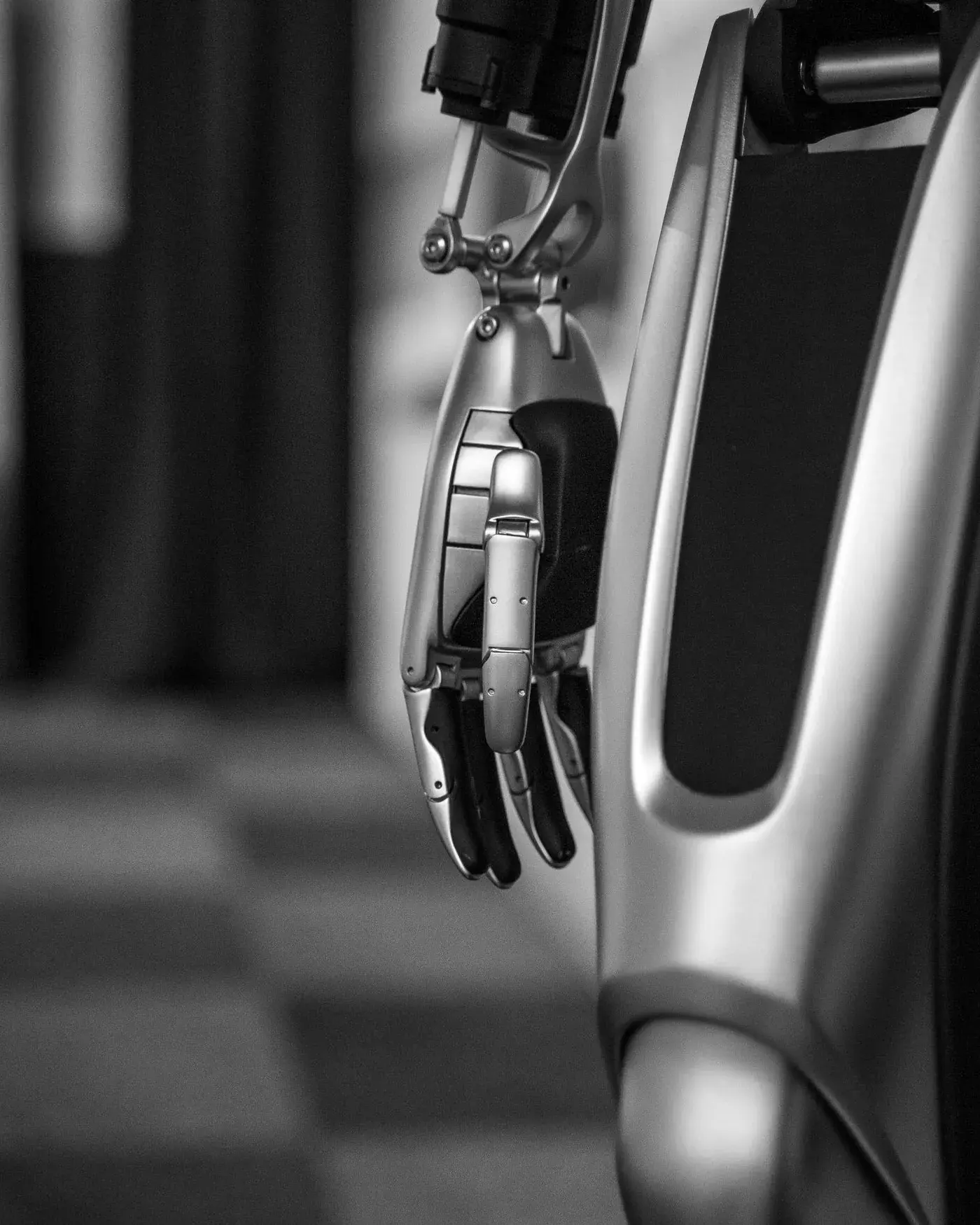 A close-up of a robotic gripper against a dark background.