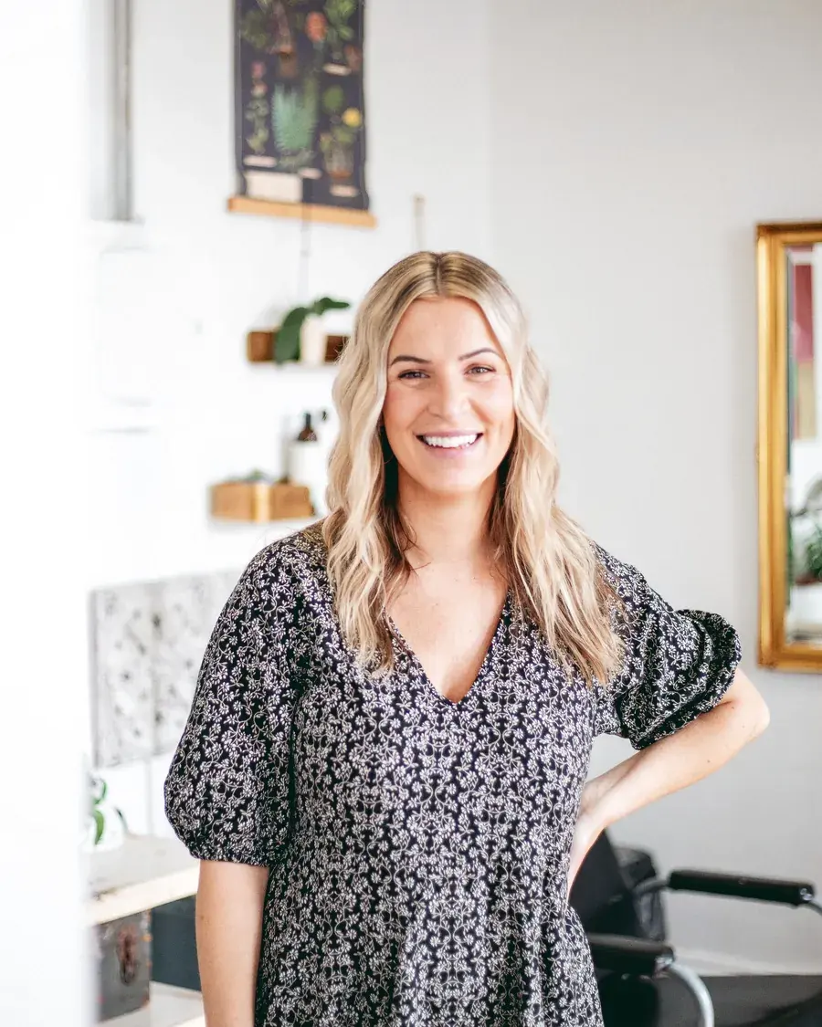 Bec Mallory standing in her hair salon.
