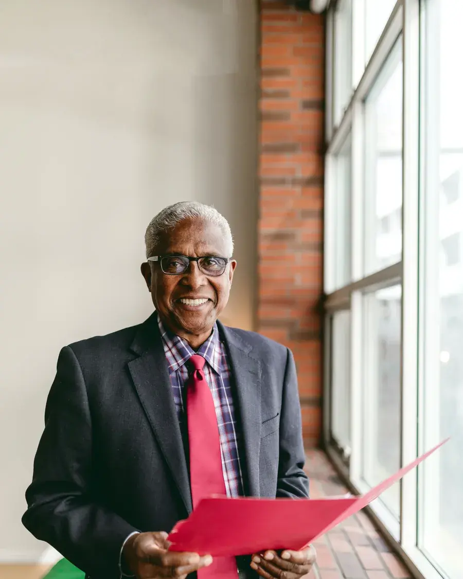 Ray Kingston standing in an office corridor by a window.