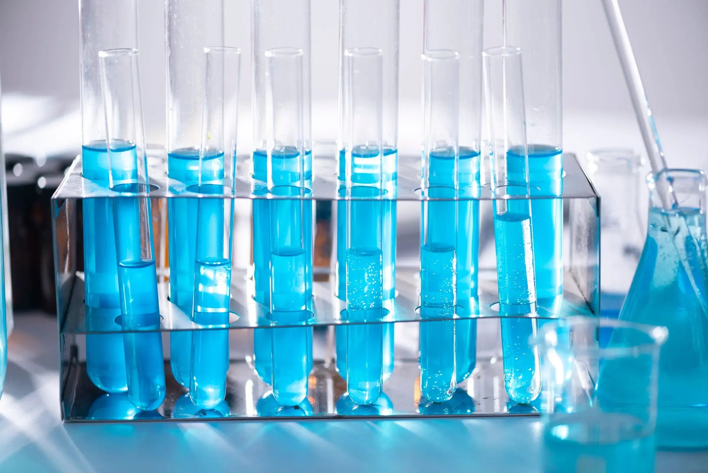 Blue reagent in glass tubes, the kind of liquid the plate is for.