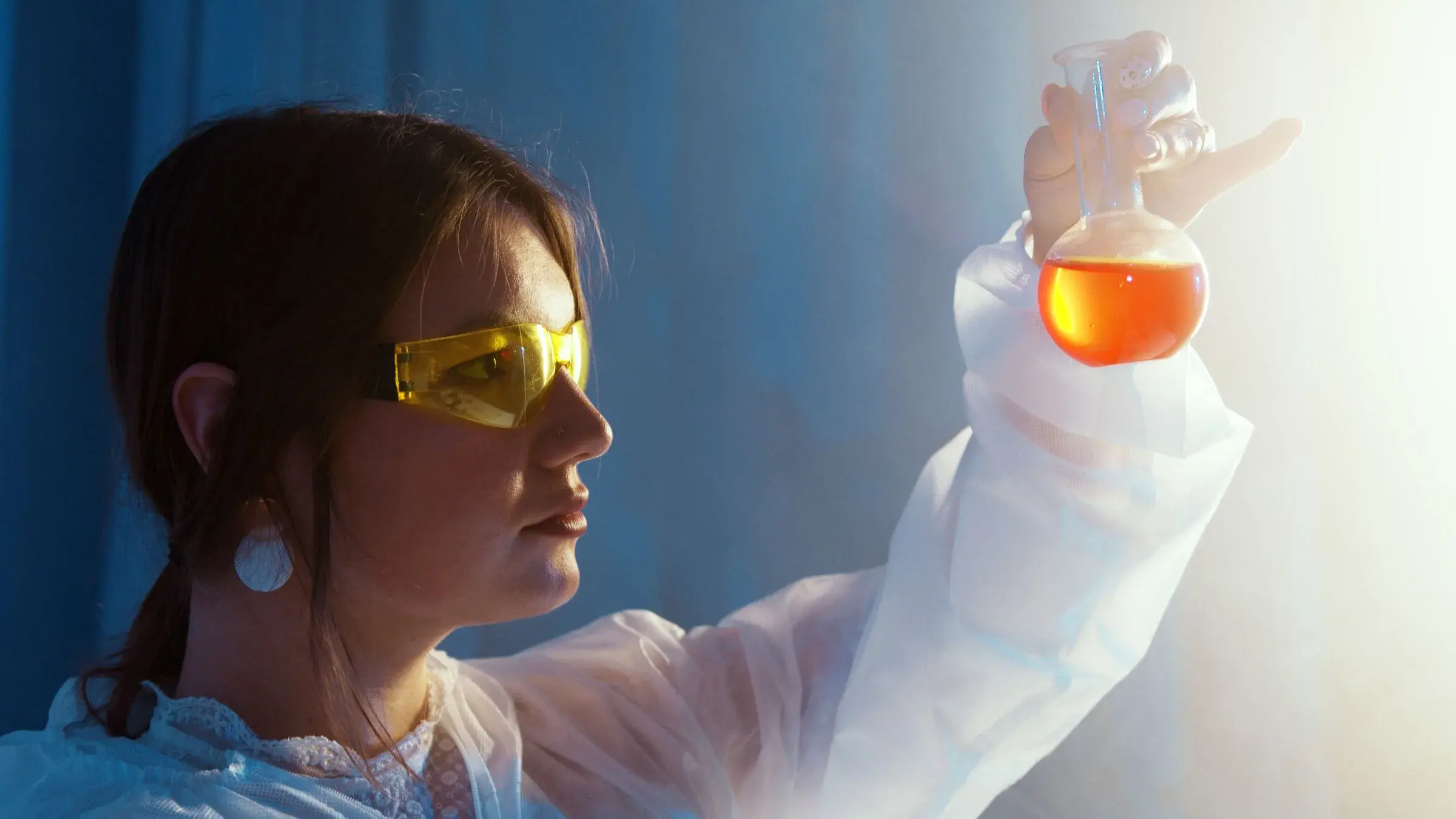 A scientist reading an orange flask, the morning after a run.