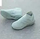 A pair of mint green boots on a concrete floor