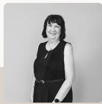 Portrait of a lawyer in a dark sleeveless dress, in black and white.