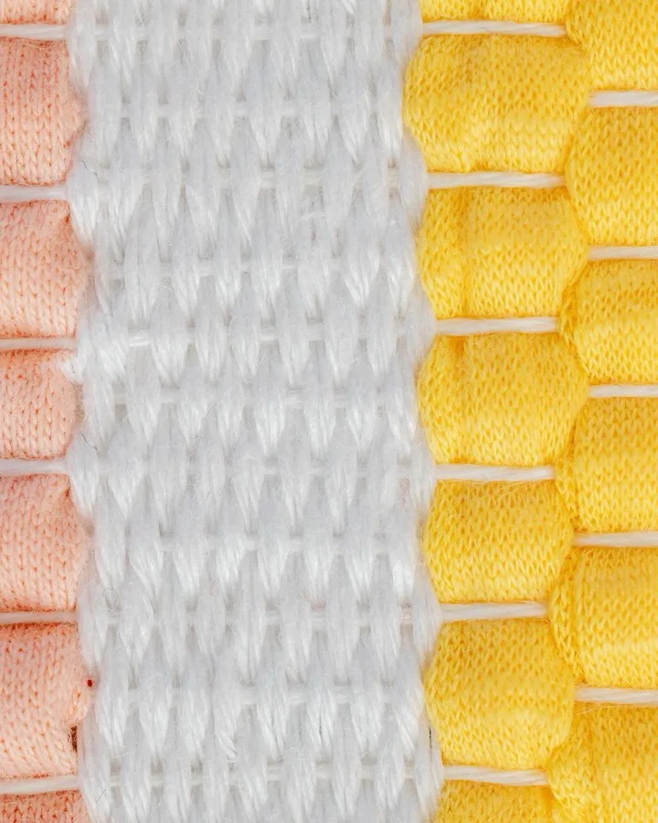 Printed sample cards in pink, cream and yellow, laid out in a grid.